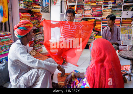 Vendor and customer in Clothing store,Sardar Market,Jodhpur, Rajasthan, India Stock Photo