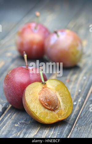 Plums on wooden table - close-up