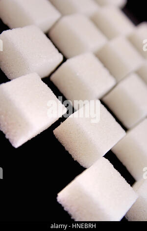 Lump sugar on black background Stock Photo