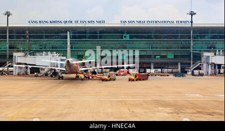 Ho Chi Minh, Vietnam - September 5, 2015: Aircraft of asian low cost airline Jet Star Air preparing for flight in front of passenger terminal building Stock Photo