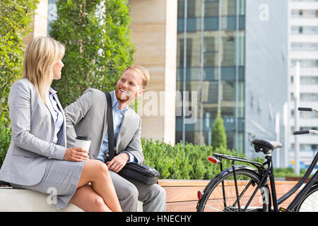 Happy businessman talking to female colleague in city Stock Photo