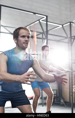 Determined men exercising at crossfit gym Stock Photo - Alamy