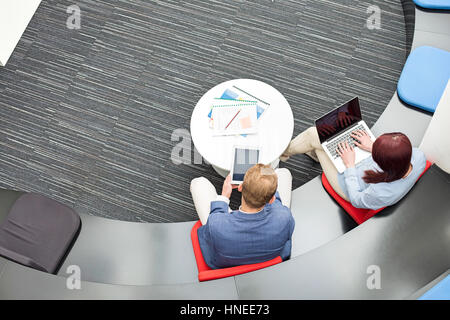 High angle view of business people using technologies in office Stock Photo