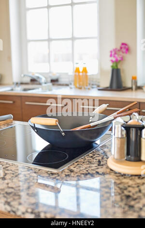 Cooking utensils on stove in kitchen Stock Photo