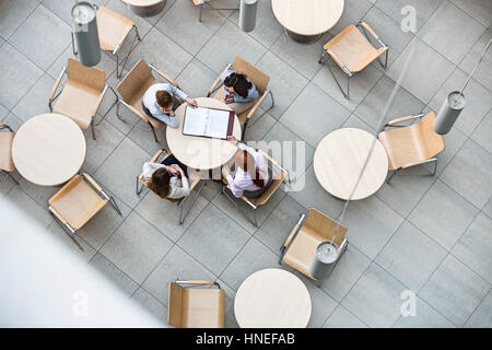 High angle view of businesswomen doing paperwork in office canteen Stock Photo