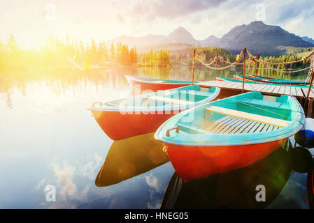 Boat on the dock surrounded mountains. Fantastic Shtrbske Pleso  Stock Photo