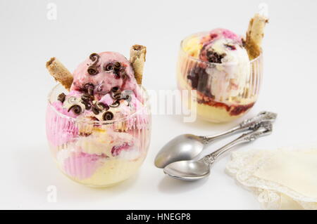 various flavors of ice cream in a glass cup with syryp on top Stock Photo
