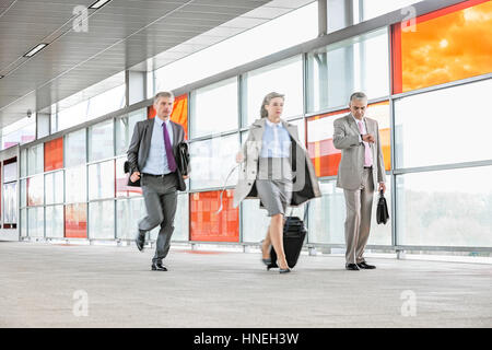 Full length of businesspeople rushing in railroad station Stock Photo