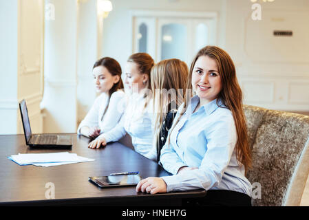 Students working together on tablet pc at the college Stock Photo