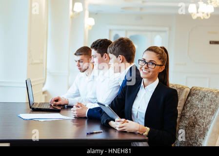 Students working together on tablet pc at the college Stock Photo