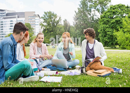 University friends studying together on grass Stock Photo