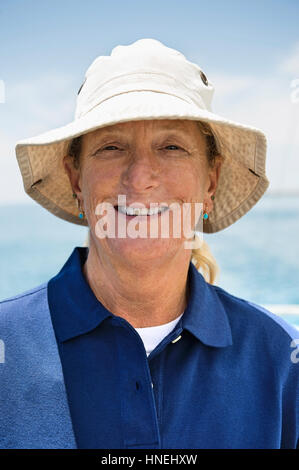 Portrait of smiling woman wearing hat on yacht Stock Photo