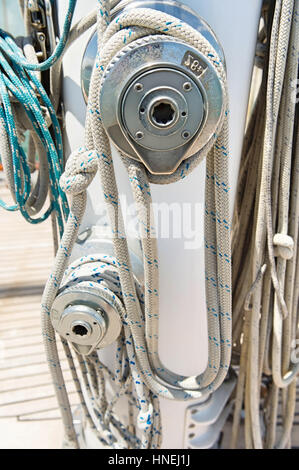Ropes wound around winches on sailboat Stock Photo