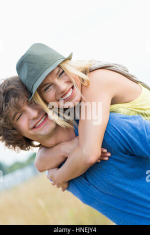 Happy young couple enjoying in field Stock Photo