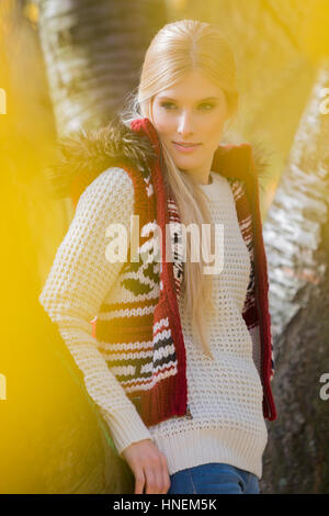 Thoughtful young woman in warm clothing standing in park Stock Photo