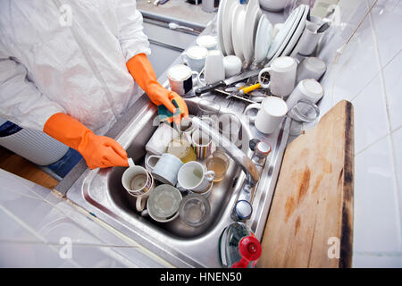 Midsection of woman washing utensil at kitchen sink Stock Photo