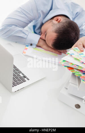 Close-up view of Caucasian businessman asleep at his desk Stock Photo