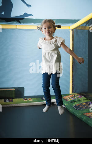 Young girl in mid air on trampoline Stock Photo
