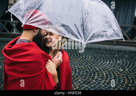 guy and girl under an umbrella Stock Photo