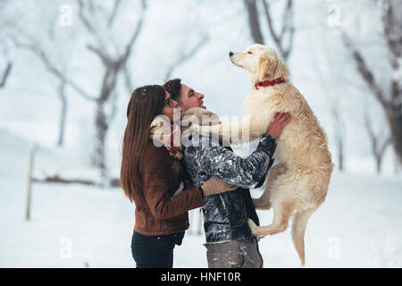 Young couple having fun in winter park Stock Photo