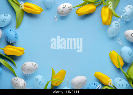 Easter eggs with tulip flower on blue background Stock Photo