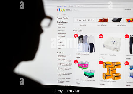 BATH, UK - SEPTEMBER 14, 2015: Close-up of the Ebay  homepage displayed on a LCD computer screen with the silhouette of a man's head out of focus in t Stock Photo