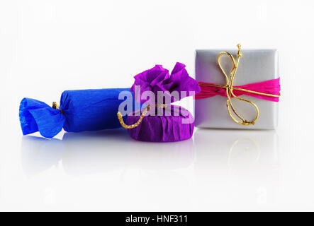 Bright colorful gift boxes with decorative ribbons and bows on a light background. Stock Photo