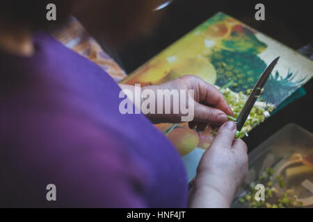 Housewife cutting fresh onion on board Stock Photo