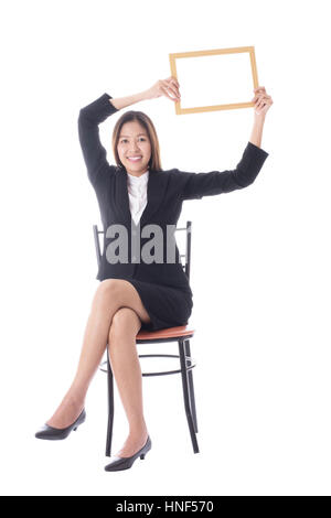 Young asian business woman pointing on copy space Stock Photo by leungchopan