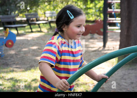 Happy child, little girl playing in a playground Stock Photo