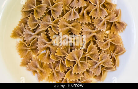 Uncooked dry whole wheat farfalle pasta Stock Photo