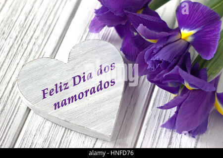 Feliz Dia dos Namorados (text in Portuguese: Happy Valentine's Day) and red  tulips blooming with green stalk against a light blue sky background. Conc  Stock Photo - Alamy