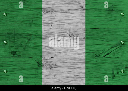 Nigeria national flag painted on old oak wood. Painting is colorful on planks of train carriage. Fastened by screws or bolts. Stock Photo