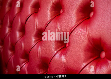 Texture of red leather sofa. Focus on the center Stock Photo