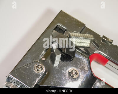 Staple gun and staples on white background closeup. Isolated. Stock Photo