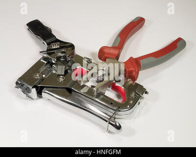 Staple gun, staples, pliers and an adjustable wrench on isolated white background Stock Photo