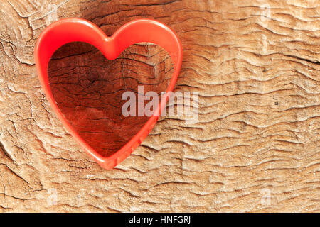 Idea for card Valentine day. Heart shaped cookie cutter on old wood background Stock Photo