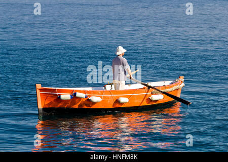 Sailor rowing on wooden taxi boat in Zadar, Croatia Stock Photo