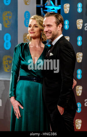 London, UK. 12th February 2017. Rafe Spall and Elize du Toit arrives at the EE British Academy Film Awards on 12/02/2017 at Royal Albert Hall, . Persons pictured: Rafe Spall, Elize du Toit . Credit: Julie Edwards/Alamy Live News Stock Photo