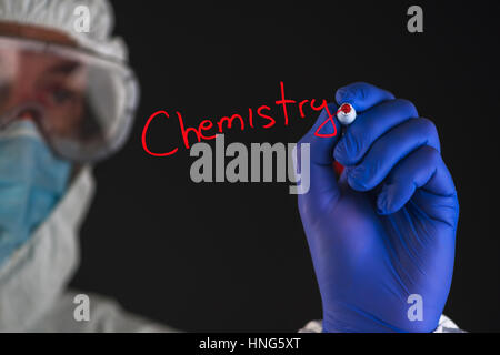 Chemical scientist writing word chemistry with red marker felt tip pen Stock Photo