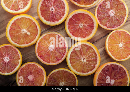 Fresh half cut oranges on wooden table Stock Photo