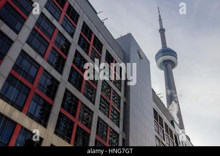 TORONTO, CANADA - DECEMBER 20, 2016: Ontario headquarters of the Canadian Broadcasting Corporation into the light with the CN Tower behind Stock Photo