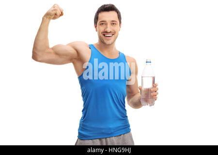 Happy young man holding a bottle of water and flexing his biceps isolated on white background Stock Photo