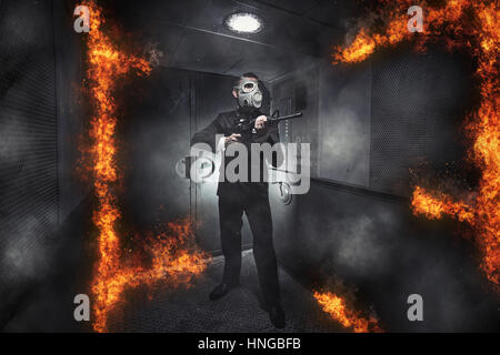 A man in a gas mask with a rifle in the old elevator Stock Photo