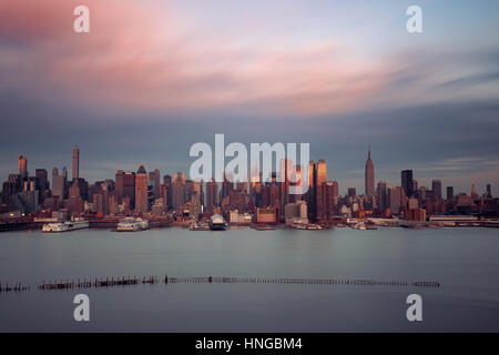 Midtown skyline over Hudson River in New York City with skyscrapers at sunset Stock Photo