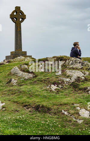 Modern life intrudes on a more ancient spiritual scene on Llanddwyn Island, Anglesey Stock Photo