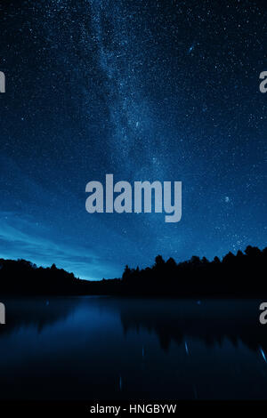 Milky Way over lake in Stowe, Vermont. Stock Photo