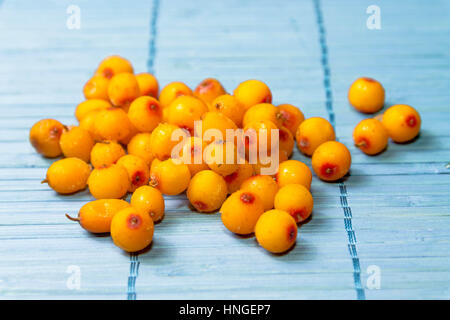 Handful of sea buckthorn. Scattered buckthorn berries. Stock Photo