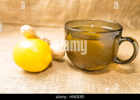 Tea with no sliced lemon and ginger root. Stock Photo