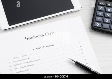 Business plan on the table with calculator and pen Stock Photo